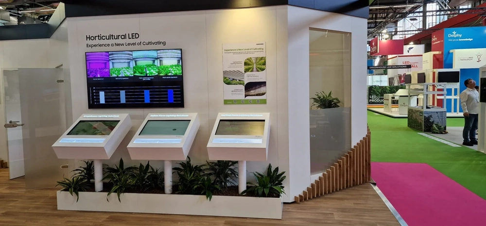 Moderner Messestand mit interaktiven Touchscreens und Pflanzen